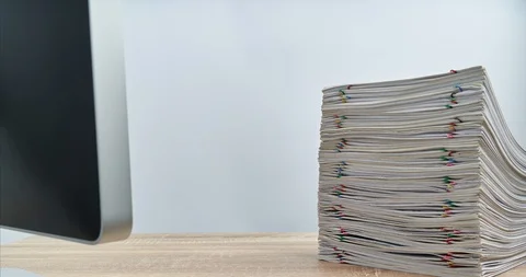 Pile overload paperwork with computer on wood table time lapse 動画素材 112966843
