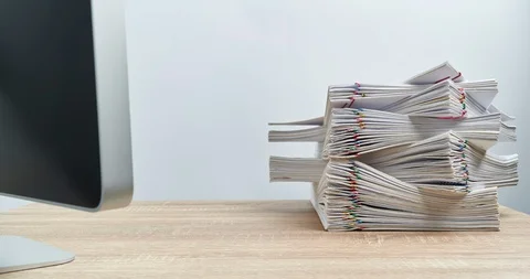 Pile paperwork overload with computer on wood table time lapse 動画素材 112966853
