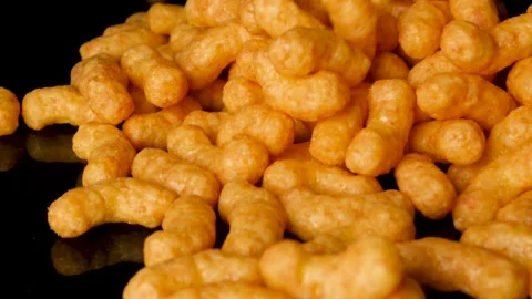 Pile of peanut flips are thrown on a black reflective surface Stock Footage 151884000
