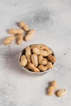 Pile of Peanuts in a bowl on a white background Foto stock