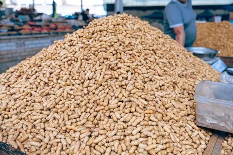 A pile of peanuts is on a table Stock Photos