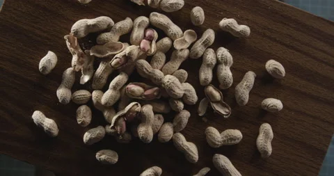 Pile of peanuts on wood table Stock Footage 146428117