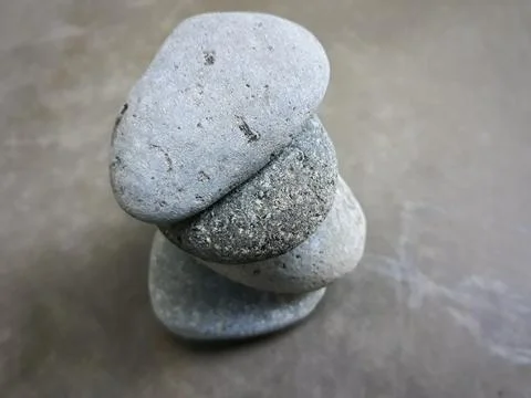 A pile of pebbles on grey background Stock Photos