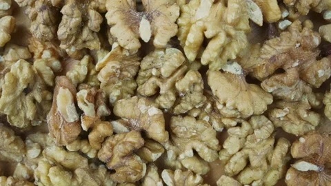 Pile of peeled half of walnut background rotate top close view. Video stock 168274055