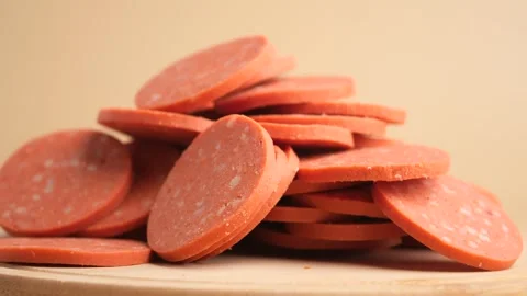 Pile of pepperoni slices in close up motion on wooden board. Stock Footage 331725924