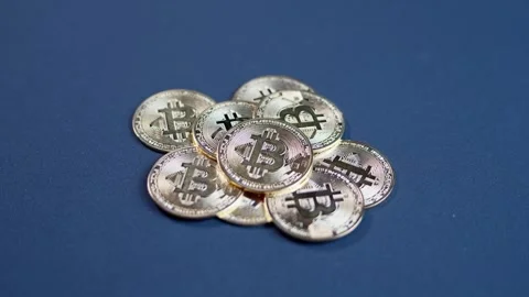 Pile of Physical Bitcoins on Dark Table Stock Footage 299878100