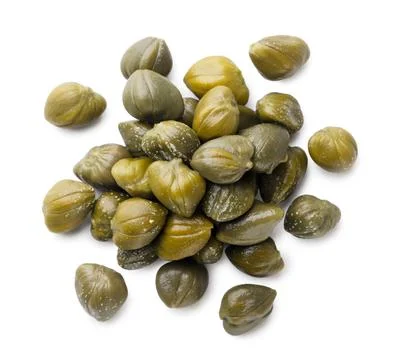 Pile of pickled capers on a white background. Top view Stock Photos