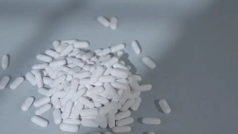 Pile Of Pills Medication On Blue Background Video stock 343328904