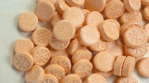 A pile of pills vitamins with an orange pattern Stock Footage 142968467