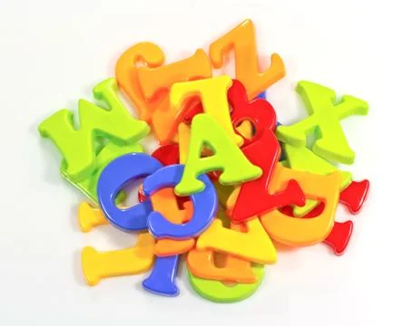 Pile of plastic alphabets on white background Stock Photos