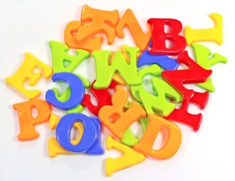 Pile of plastic alphabets on white background Stock Photos