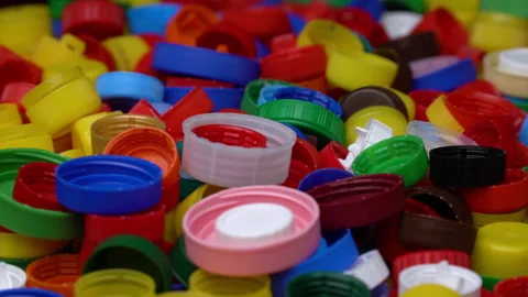 Pile of plastic caps in different colors. Rotating background of many colorful Stock Footage 203919857