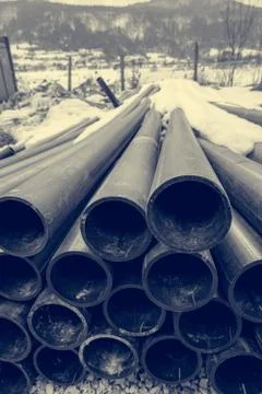Pile of plastic pipes on construction site ready to be used. Stock Photos