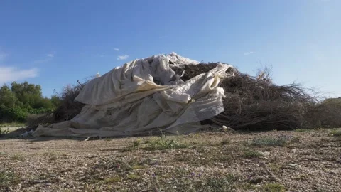 Pile of plastic sheets moved by wind. Plastic waste, no plastic, greenhouses was Stock Footage 137300975