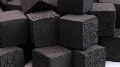 Pile of pressed coal cubes for hookah stacked together on white background Stock Footage 311326225