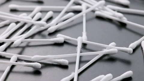 Pile of q-tips or cottom buds slowly rotating on black background Stock Footage 189919620