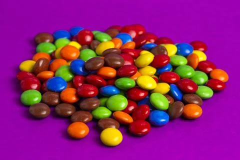 A Pile of Rainbow Colored Candy Coated Chocolate Buttons Stock Photos