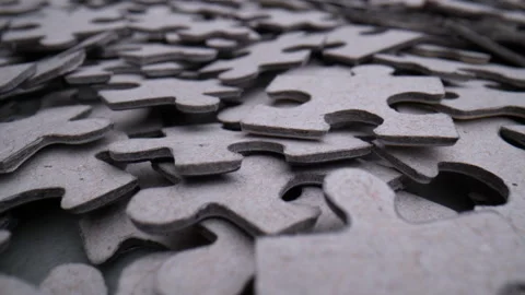 Pile of randomly lying puzzle or jigsaw pieces Stock Footage 199493173