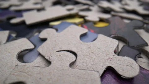 Pile of randomly lying puzzle or jigsaw pieces Stock Footage 199498239