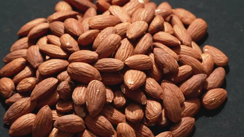 Pile Of Raw Almonds Rotating With Strong Backlight 4K Stock Footage 332844974