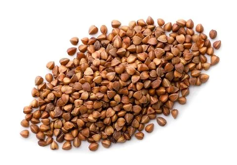 Pile of raw buckwheat on a white background. Top view Stock Photos