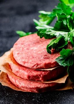 Pile raw burger on the table. Stock Photos