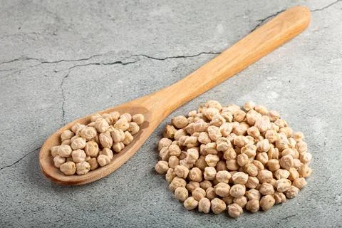 Pile of raw chickpeas on the table. Stock Photos