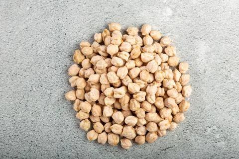 Pile of raw chickpeas on the table. Stock Photos