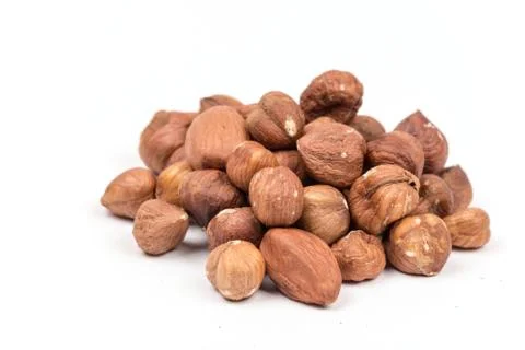 Pile of raw hazelnuts over white background Foto stock