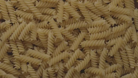 Pile of raw Italian fusilli pasta rotating 360 degrees UNGRADED Video stock 119293353