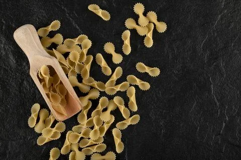 Pile of raw macaroni on black background Stock Photos