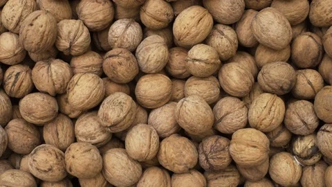 Pile of raw walnuts on the stock texture, top view, dolly. Stock Footage 219891678