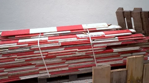 Pile of red and white blocking wood for securing construction sites for road Stock Footage 263645719