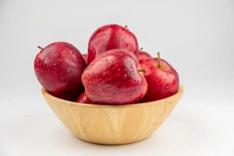 Pile of red apple in wooden bowl with clear water drop on shell surface texture Stock Photos