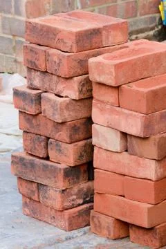 Pile of red bricks on construction site Stock Photos
