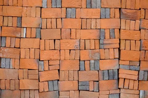 Pile of red bricks on a construction site. brick stacked background texture Stock Photos