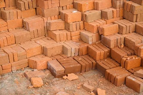 Pile of red bricks on a construction site. brick stacked background texture Stock Photos