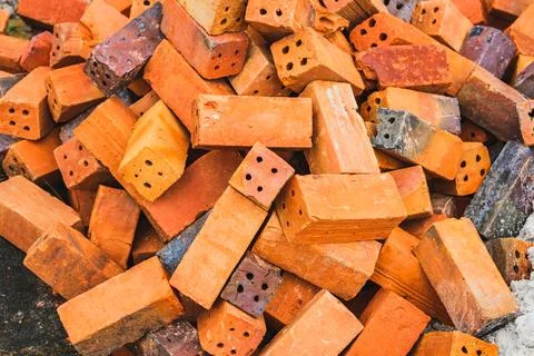 Pile of red clay building bricks at construction site Foto stock