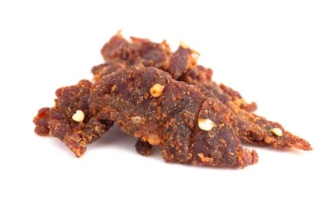A Pile of Red Pepper Beef Jerky on a White Background Stock Photos