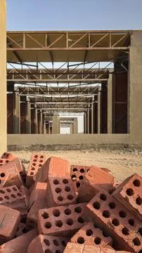 Pile of red perforated bricks at a building construction site Stock Photos