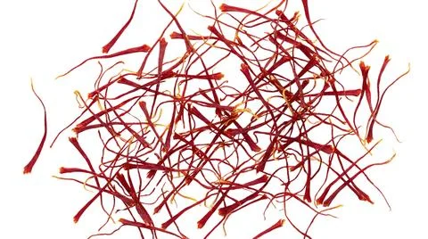 Pile of red saffron threads isolated on white background natural culinary spi Stock-Fotos