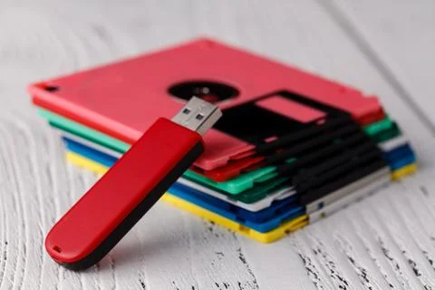 Pile of retro floppy disk versus usb flash driver Stock Photos