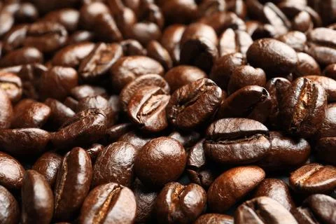 Pile of roasted coffee beans as background, closeup Stock Photos