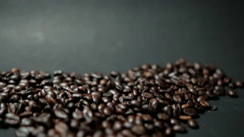 Pile of roasted coffee beans on black surface Stock Footage 162523556