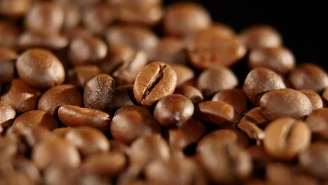 A pile of roasted coffee beans rotating. Close up Stock Footage