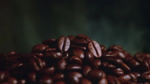 Pile of roasted coffee beans with smoke stock video footage macro. Stock Footage 345159341