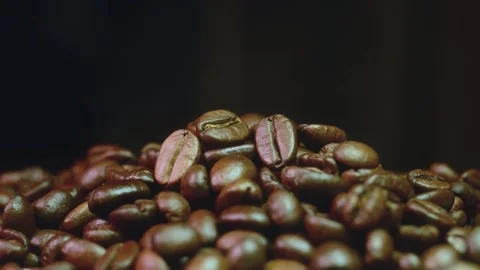 Pile of roasted coffee beans stock video footage close up on dark surface Video stock 345159336
