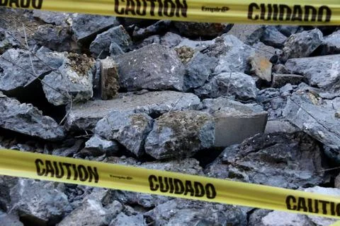 A pile of rocks with caution sign Stock Photos