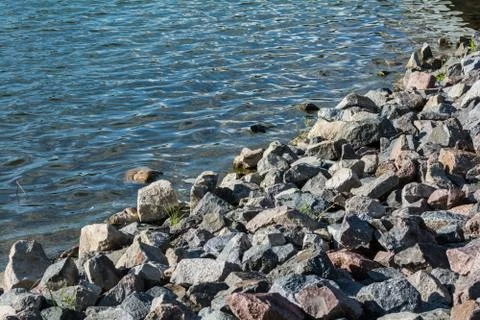 Pile of rocks on lakeside Stock Photos