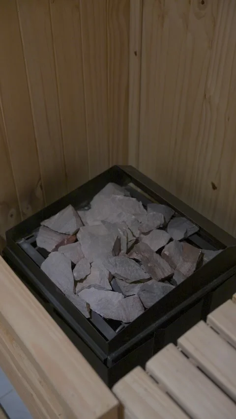 A pile of rocks sits on top of a grate in a wooden structure Stock Footage 330895847